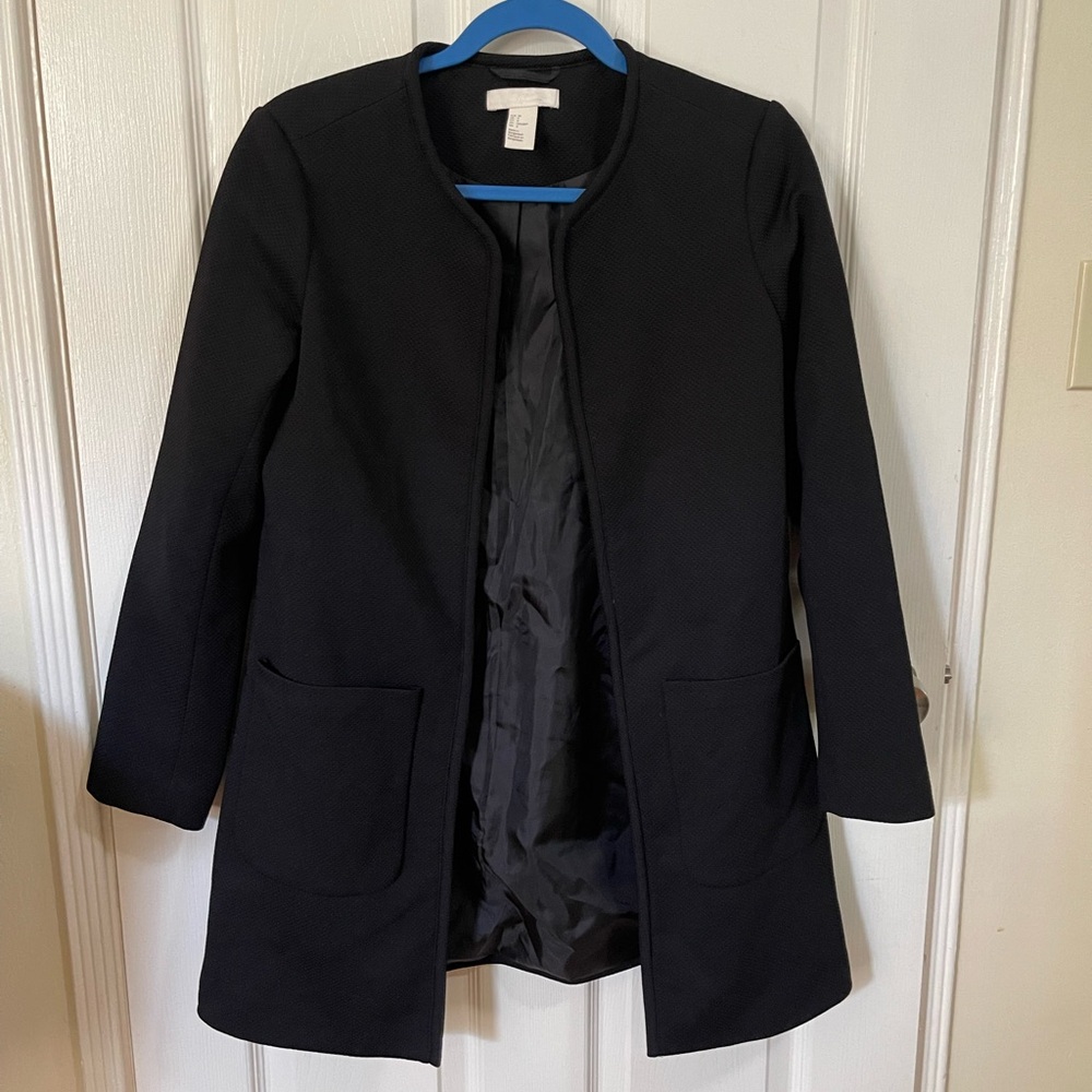 H&M collarless black coat jacket with front pockets fully lined.